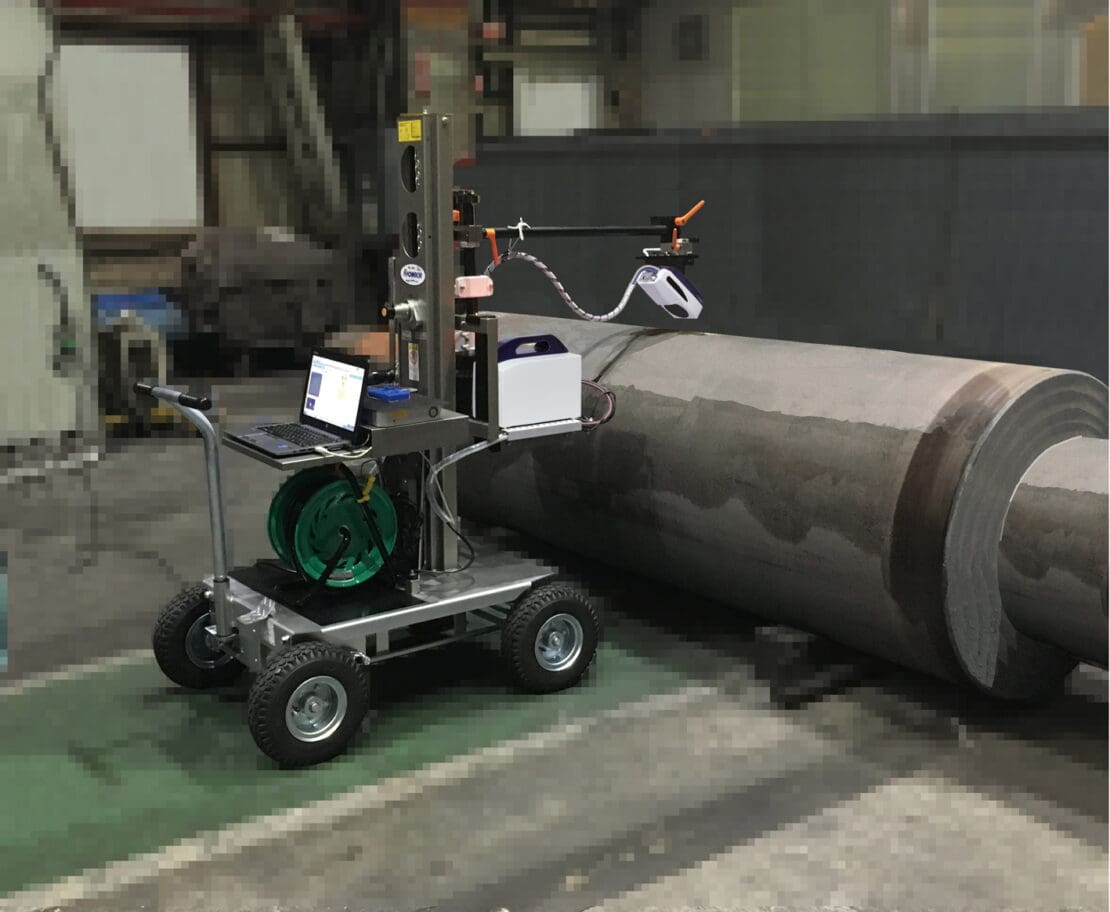 The μ-X360s is attached to a moveable cart and is measuring a section of rolled steel.